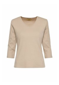 Beżowa bluzka z długim rękawem wykonana z prążkowanej tkaniny. Posiada dekolt w serek i małe logo na dolnym brzegu. Prosty krój i miękka tekstura.
