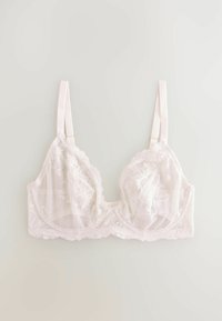 Reggiseno bianco in pizzo con motivi floreali, coppe trasparenti e bordi a scallop. Presenta spalline in raso regolabili e una fascia morbida sotto.