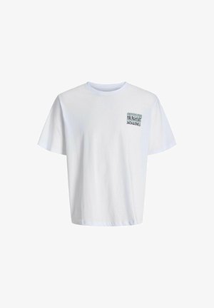 Hvid bomulds t-shirt med et lille grafik på venstre bryst, parret med lyseblå baggy denim jeans og sort-hvide sneakers.