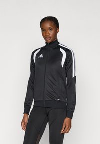 Μαύρο αθλητικό σακάκι με ψηλό γιακά, λευκές ριγέ λεπτομέρειες, κλείσιμο με φερμουάρ και λογότυπο "climacool" στη μέση. Λείο, ελαφρύ ύφασμα.