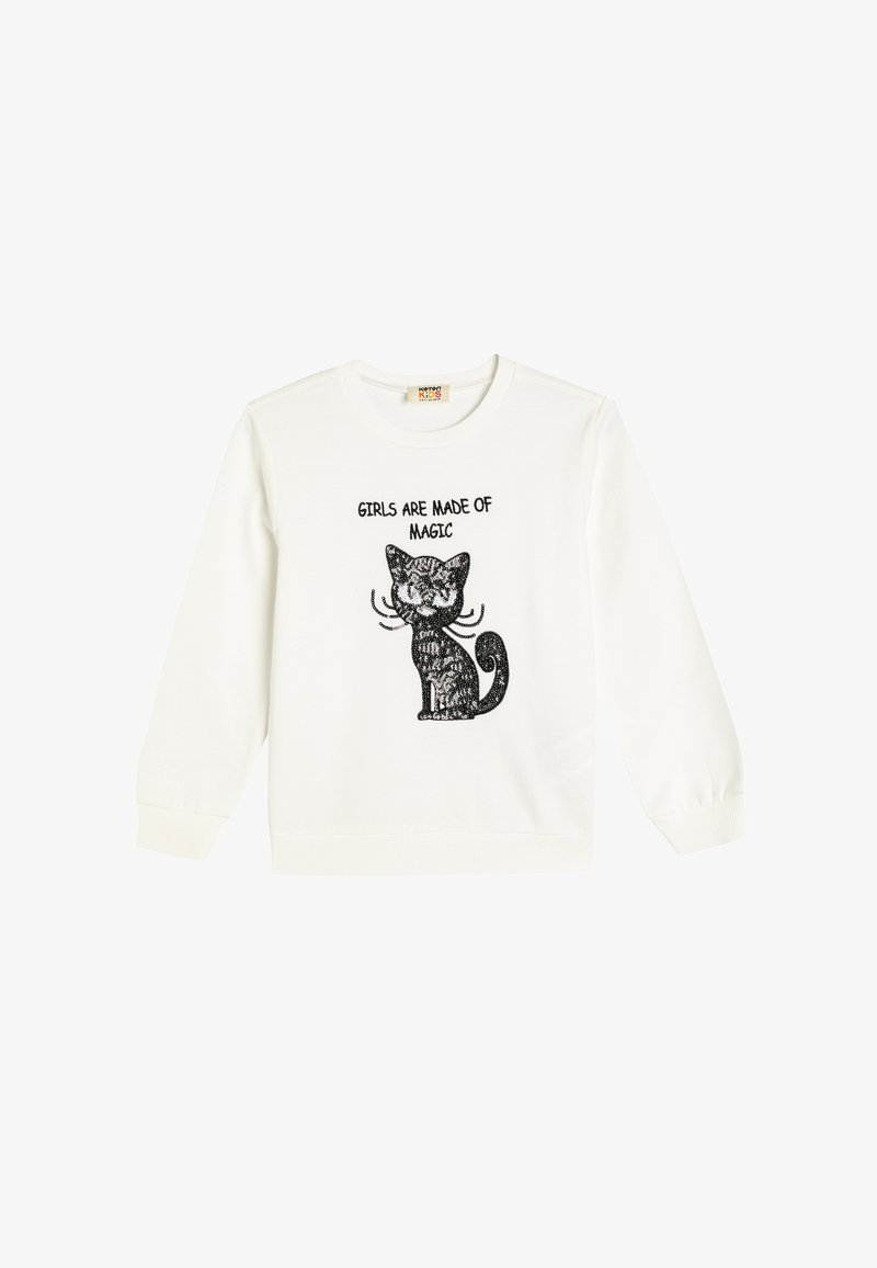 Sweatshirt bianco con maniche lunghe che presenta una grafica di un gatto nero e il testo "LE RAGAZZE SONO FATTE DI MAGIA" in grassetto sopra il design.