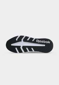 Μαύρη και λευκή σόλα παπουτσιού Reebok με υφή που προσφέρει πρόσφυση και το λογότυπο Reebok στην περιοχή της φτέρνας.