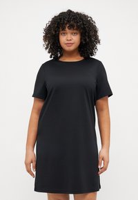 Black T-shirt dress in a smooth fabric with a round neckline and short sleeves, featuring a relaxed fit and knee-length design.