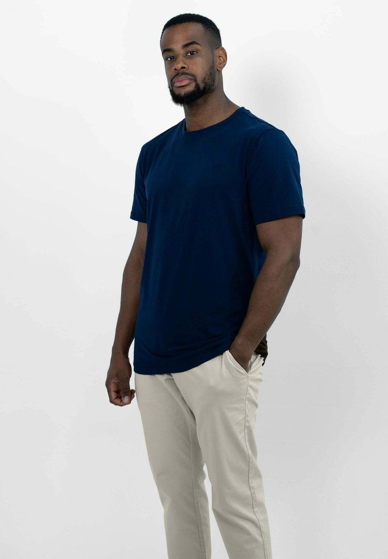 Marineblauwe t-shirt met korte mouwen in een gladde katoenmix, gecombineerd met crèmekleurige, slim-fit chino's met zijzakken.