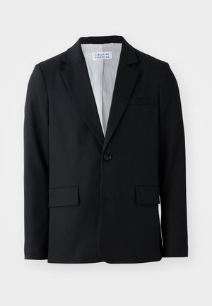 Must mustri mustaga lõikega must bleiser, millel on ühe nööbi sulgemine, soonega krae ja kolm taskut, sealhulgas üks rinnatasku.