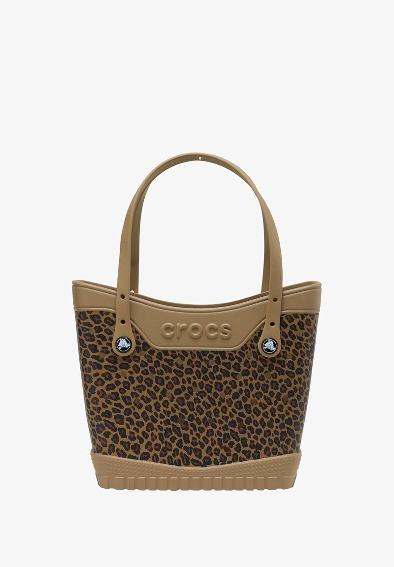 Sac fourre-tout en imprimé léopard avec un matériau en caoutchouc beige, doté de deux poignées robustes, d'un nom de marque embossé et d'accents noirs sur les côtés.