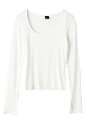 Haut blanc à manches longues en tissu lisse, doté d'un col arrondi et d'une coupe courte avec une apparence simple et épurée.