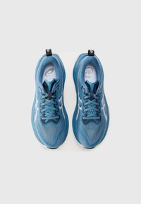 Blue running shoes with mesh and synthetic upper, featuring a textured design and contrasting dark laces, reflective accents, and black heel tab.