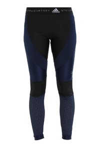 Merin urheiluleggingsit, joissa on yhdistelmä sileitä ja verkko-tekstuureja. Mustia osia ja leveä, kuvioitu vyötärö, jossa on brändilogo.