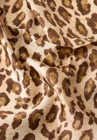 Beżowa tkanina z brązowymi i jasnobrązowymi cętkami lamparta, miękka w dotyku, przedstawiona w delikatnych fałdach i zagnieceń.