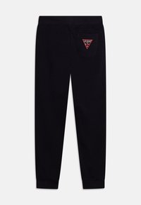 Sorte joggebukser med en avsmalnet passform, laget av bomull. Har et trekantet rødt logoklistremerke på baklommen. Myk tekstur, elastisk midjebånd.