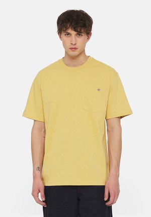 Yellow cotton t-shirt with short sleeves, crew neck, and a chest pocket featuring a small logo. Smooth texture and relaxed fit.