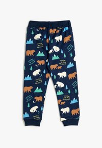 Pantalones de pijama de color azul marino con un diseño de osos y montañas en marrón, blanco y verde. Cintura elástica, textura suave y diseño ajustado.