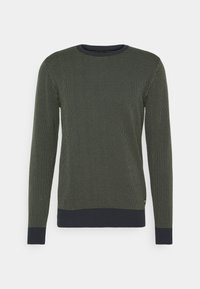 Tummanvihreä neulepaita, jossa hieno pistekuvio, pitkät hihat ja yhtenäinen laivastonsininen resori pääntiessä ja helmassa, valmistettu pehmeästä kankaasta.