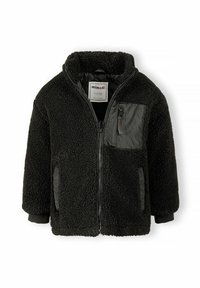 Veste en polaire noire avec une surface texturée, fermeture éclair sur le devant et une poche poitrine noire mate. Comprend des poignets et un col côtelés.