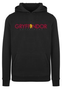 Fekete kapucnis pulóver kenguru zsebbel, nagy piros "GRYFFONDOR" felirattal és aranyoroszlán emblémával. Puha, szövet textúra.