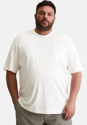 T-shirt bianca a maniche corte con scollo rotondo e tasca sul petto. Realizzata in tessuto morbido, presenta una vestibilità comoda e una texture liscia.