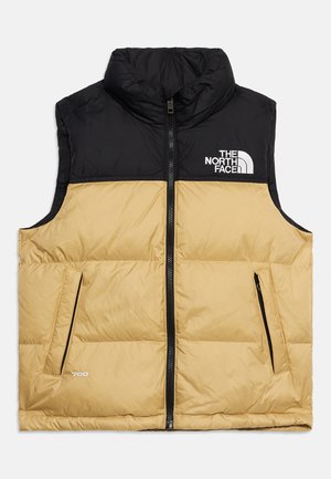 Vestă matlasată fără mâneci, cu secțiune superioară neagră și secțiune inferioară bej, cu fermoar frontal, buzunare laterale și logo The North Face pe piept.