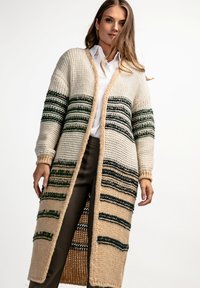 Długi, otwarty kardigan w kolorze kremowym z zielonymi i brązowymi paskami. Dzianinowa faktura, ściągacze przy mankietach oraz luźny krój. Elegancki i ciepły.
