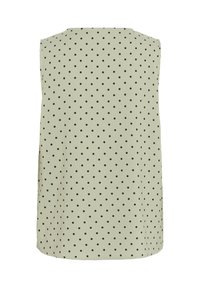 Haut sans manches vert clair à pois noirs, vu de dos sur fond blanc.