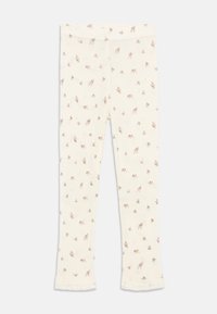 Leggings crème avec un motif floral délicat en marron doux et rose, présentant une bordure en dentelle à l'ourlet. Fabriqués en tissu léger et extensible.