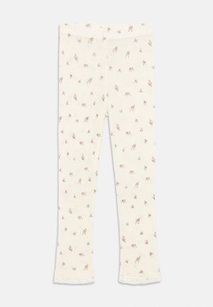 Leggings crème avec un motif floral délicat en marron doux et rose, présentant une bordure en dentelle à l'ourlet. Fabriqués en tissu léger et extensible.