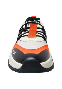 Sneaker with a white mesh upper, orange and black accents, black laces, and a textured rubber sole. Features a prominent branded logo.
