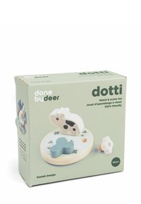 Juguete de madera para niños que incluye fósforos y tornillos, con formas de vaca y flores azules sobre una base redonda, diseñado para niños a partir de 18 meses.