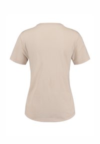 T-shirt beige à manches courtes, en coton doux, à col rond, à ourlet droit, texture légère, design minimal, sans graphiques ni motifs.