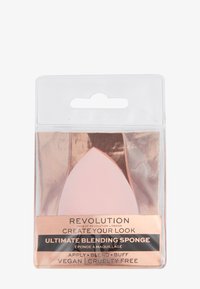 Roze latex mengspons met een druppelvorm, verpakt in doorzichtig plastic met een roségouden basis en zwarte tekst.