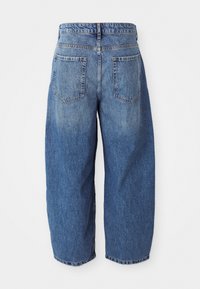 Blue high-waist wide-leg jeans with two back pockets, visible seams, and a slightly faded texture hanging against a white background.