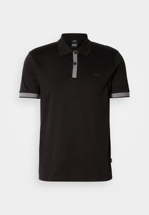 Black polo shirt with a grey collar and sleeve accents, featuring a two-button placket and small logo on the chest. Cotton material.