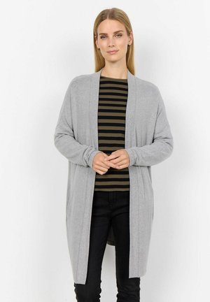Grey cardigan with open front, long sleeves, and soft texture, layered over a black and olive striped top, paired with black jeans.