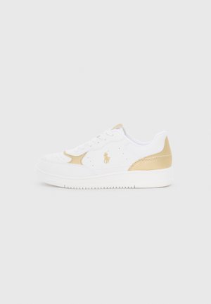 White sneakers with gold accents, perforated detailing, and a logo. Smooth material, round toe, flat sole, and classic lace-up design.