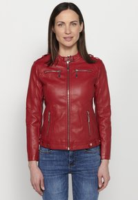 Red leather jacket with a fitted design, zippered pockets, and a stand-up collar. Features smooth texture and silver hardware accents.