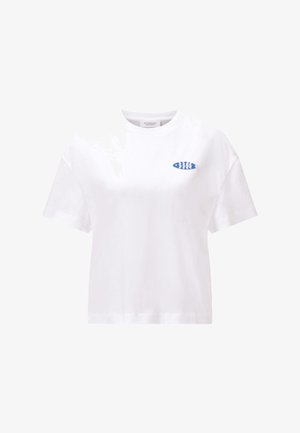 Bijela majica kratkih rukava s malim plavo-bijelim prugastim zakrpom u obliku ribe na lijevoj strani prsa.