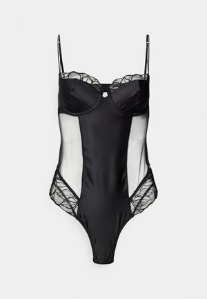 Melnas bodysuit ar pamatniem ar stieplēm, caurspīdīgām mežģīnēm sānos un mežģīņu apdari augšpusē un sānos. Regulējamas siksniņas. Augsta griezuma kāja.