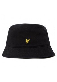 Chapeau seau en coton noir avec un large bord, présentant un petit logo brodé jaune à l'avant. Design simple et sans embellissement.