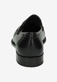 Zwarte leren dresschoenen met een gladde afwerking, ronde neus en minimalistisch ontwerp. Voorzien van een lage hak en subtiele stiksels.