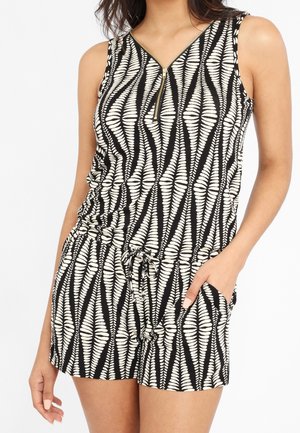 Black and white patterned romper with a V-neck, side pockets, and a zip closure. Made of lightweight fabric with a drawstring waist.
