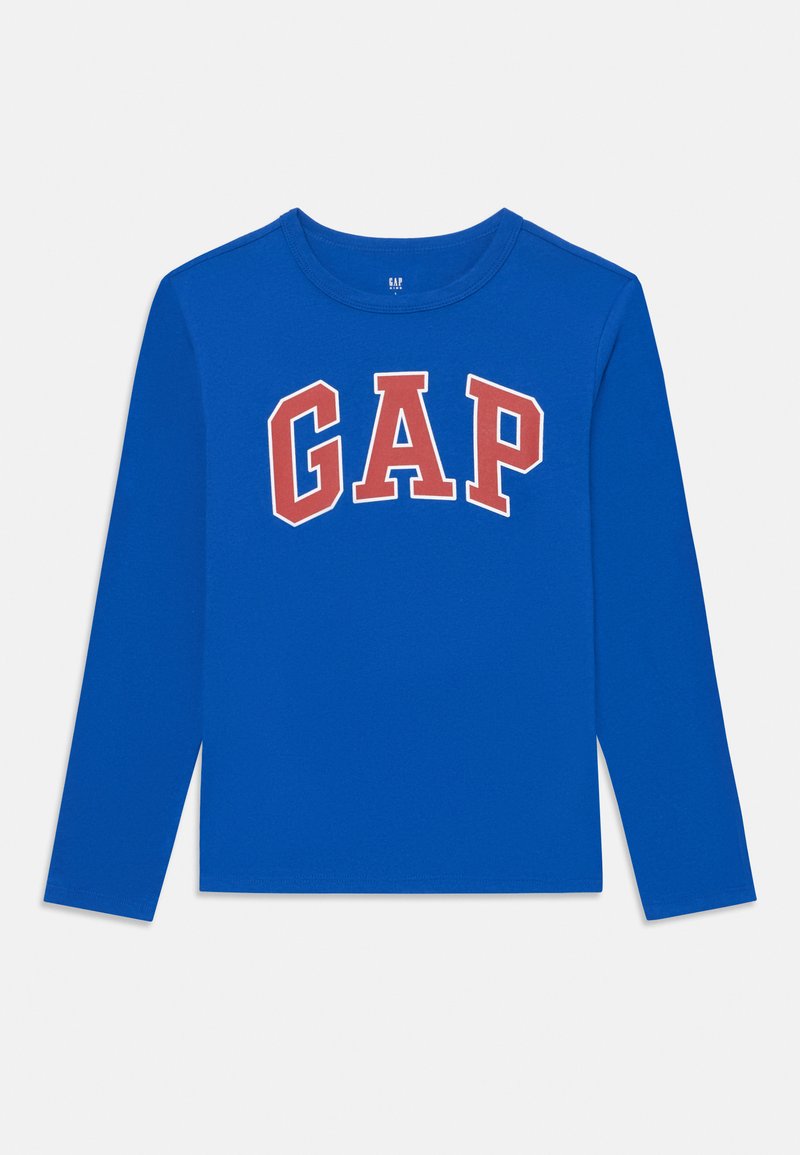 Ilgi piedurkņu zils kokvilnas T-krekls ar lielu sarkanu "GAP" logotipu uz krūtīm biezā fontā. Mīksta tekstūra un regulāra piegriezuma.