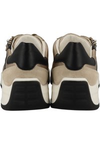 Des sneakers avec une tige en cuir noir, des accents en daim beige, de épais semelles blanches et des semelles extérieures en caoutchouc noir texturé. Comprend des éléments en métal.