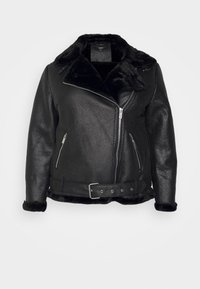 Giacca in pelle nera con colletto e foderatura in pelliccia nera morbida. Presenta tasche con zip, chiusura frontale con zip e vita con cintura e dettaglio fibbia.