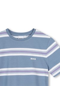 T-shirt a maniche corte a righe di colore azzurro chiaro con righe orizzontali bianche e viola; presenta un collo tondo e un piccolo logo "BOSS" sul petto.