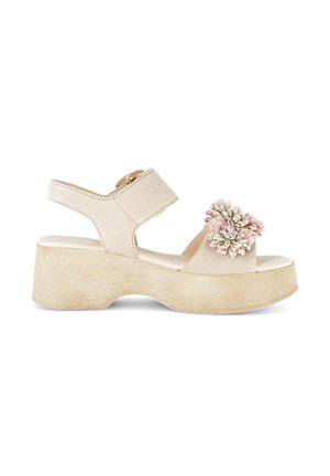 Beige platform sandal with ankle strap and large textured pink and cream flower embellishment on front strap.