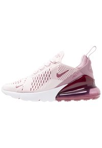 Nike Air Max sneaker featuring a light pink mesh upper, white midsole, and dark pink translucent heel. Notable for its perforated design.