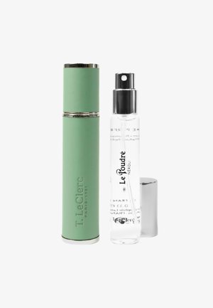 Green cylindrical perfume case and a clear spray bottle labeled "Le Poudré Néroli" with a silver cap next to it on a white background.