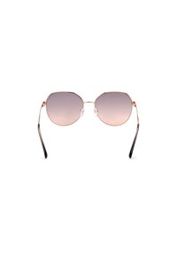 Kahdeksankulmaiset aurinkolasit, joissa on gradienttilinssit. Ohut metallinen rose gold -kehys, mustat tempelit ja läpinäkyvät nenätyynyt. Minimalistinen, ilman koristeita.