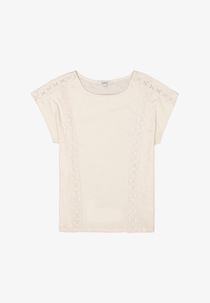 Crème-kleurige t-shirt met korte mouwen. Heeft ingewikkelde kantdetails langs de schouders en verticale naden, gemaakt van een zachte stof.