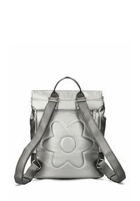 Sac à dos argenté métallique avec un motif de fleur texturé à l'arrière, doté de bretelles réglables et d'une poignée supérieure pour le transport.